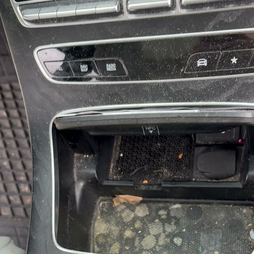 Mercedes center console before detailing with dirt and debris