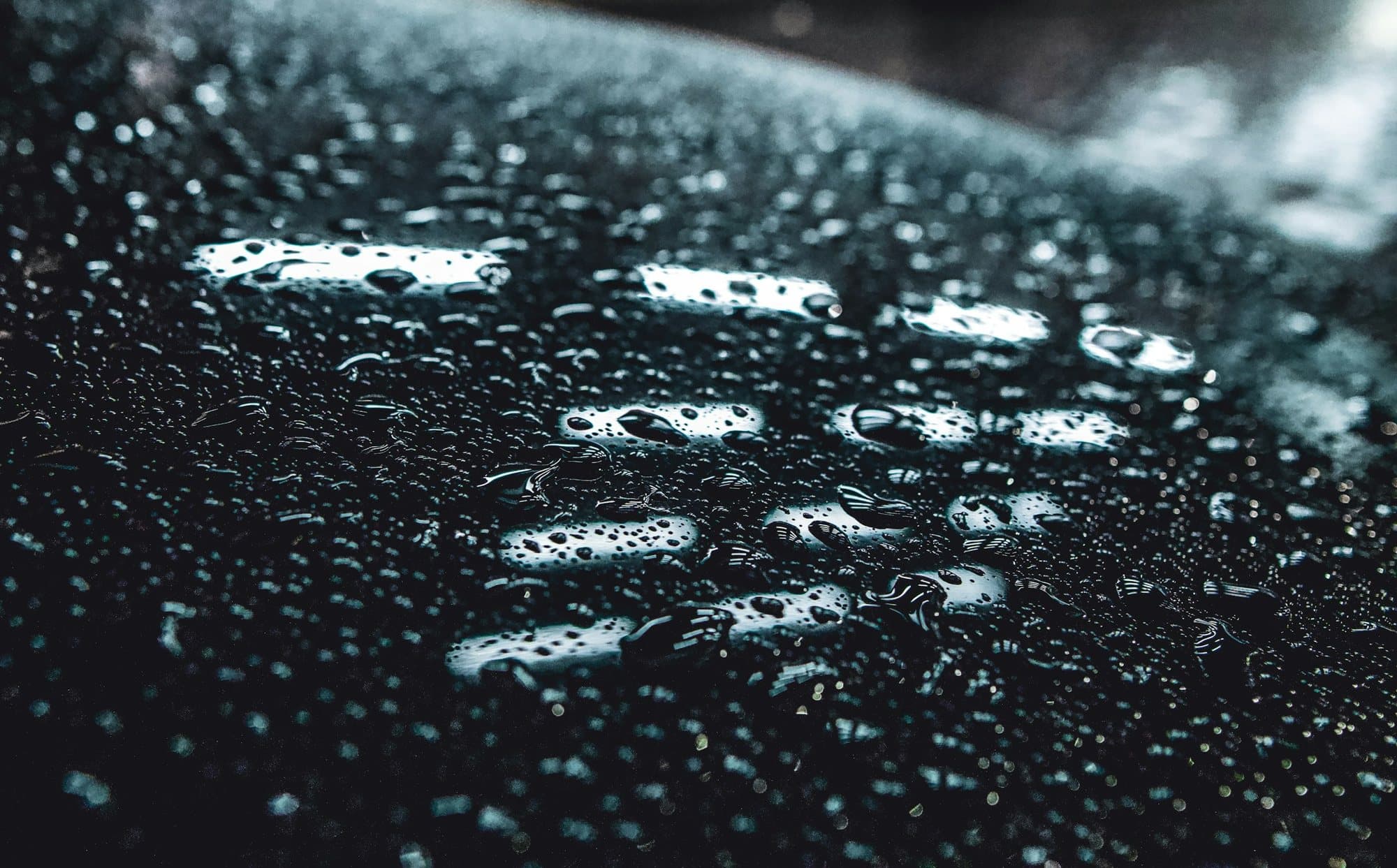 Water beading off a freshly ceramic coated car surface