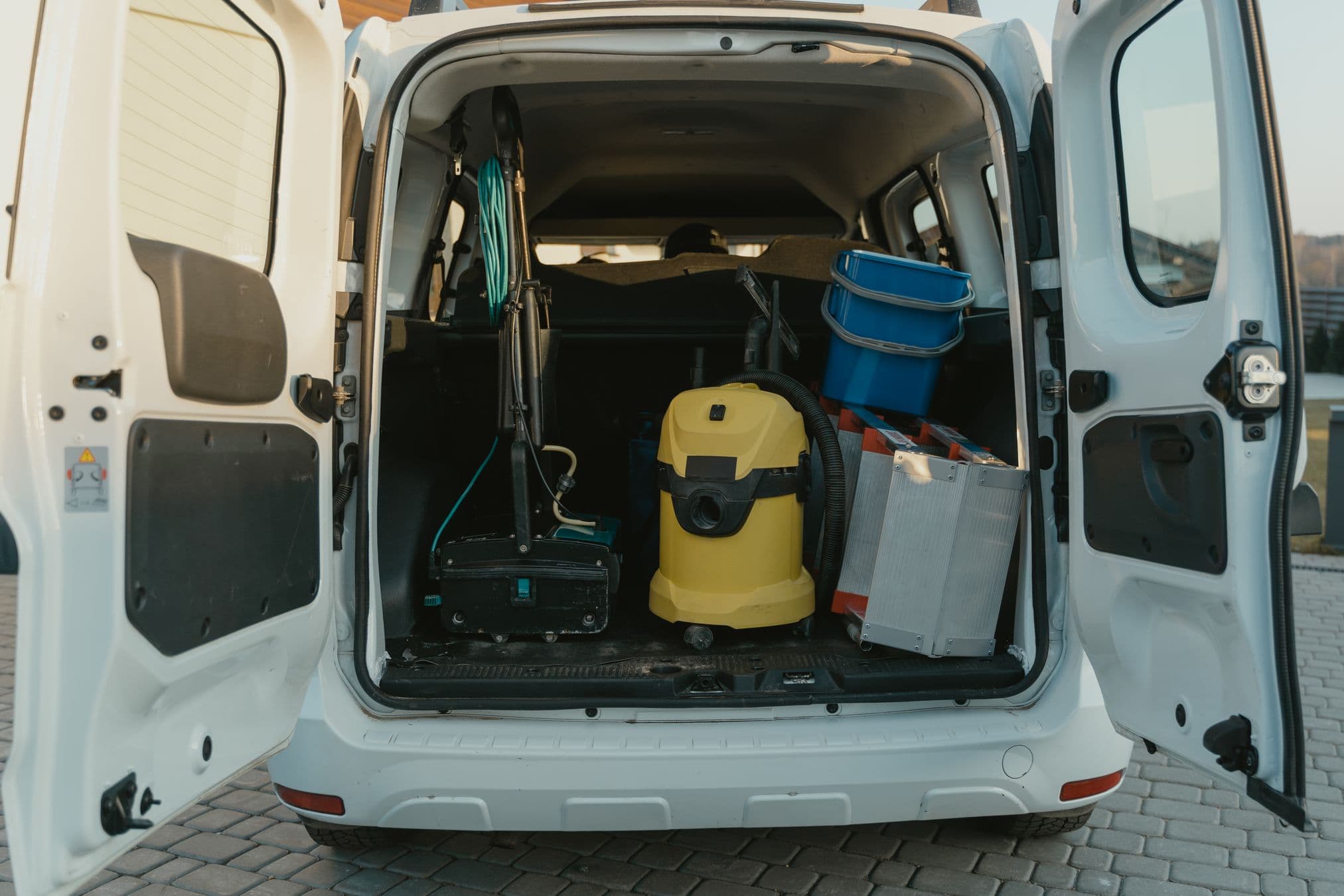 Self-contained mobile detailing van with water tank and equipment